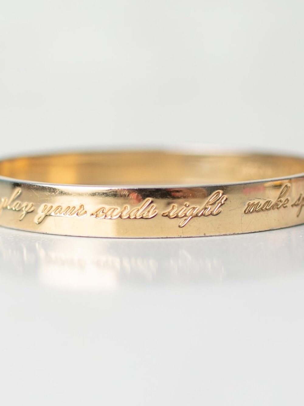 Kate Spade New York Idiom Gold Tone Bangle Bracelet Engraved Quote